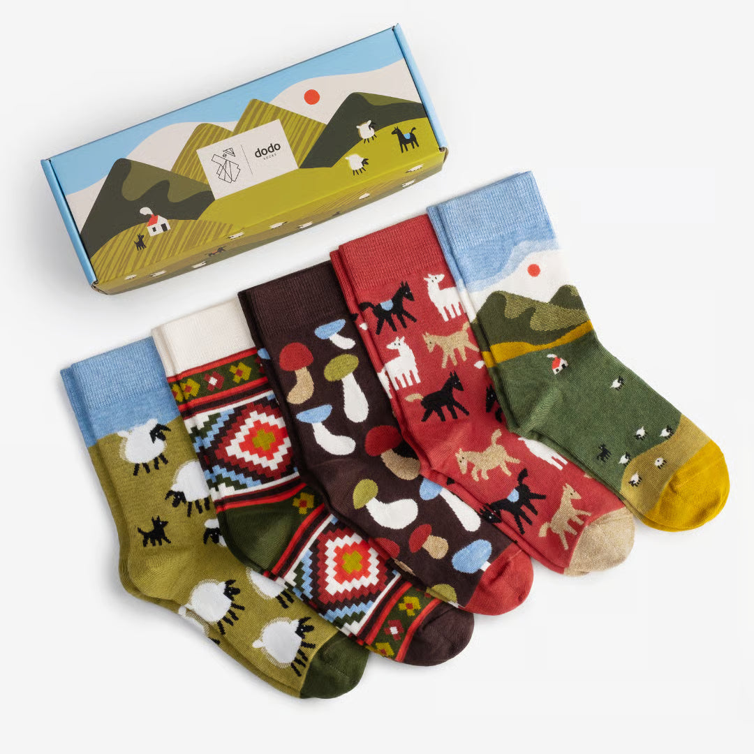 Set of colorful socks with animal patterns and a matching box on a white background