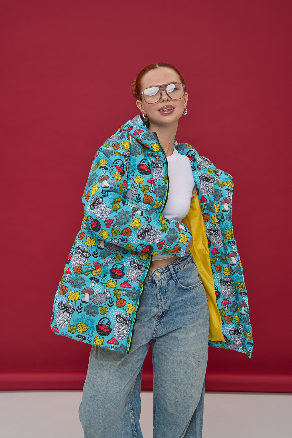 Person wearing a colorful patterned jacket against a red background